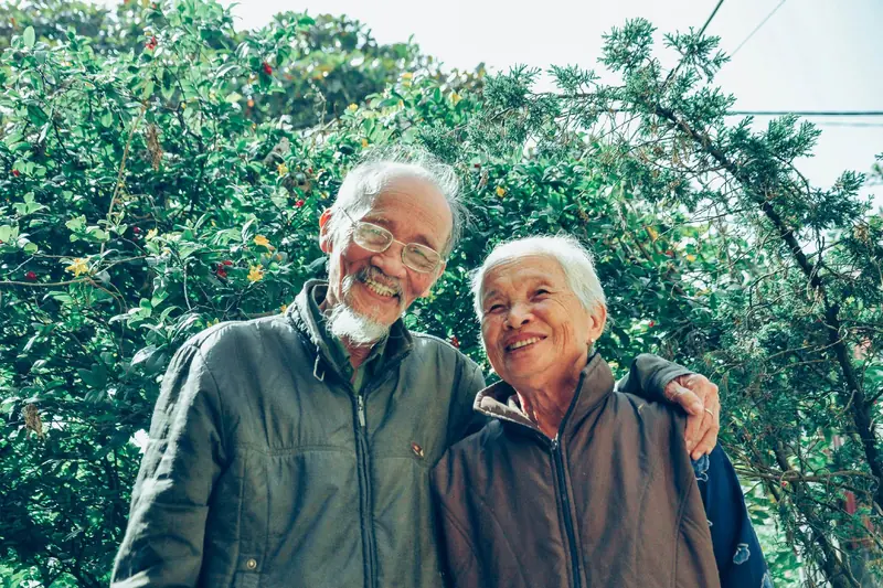 Older couple smiling together outdoors